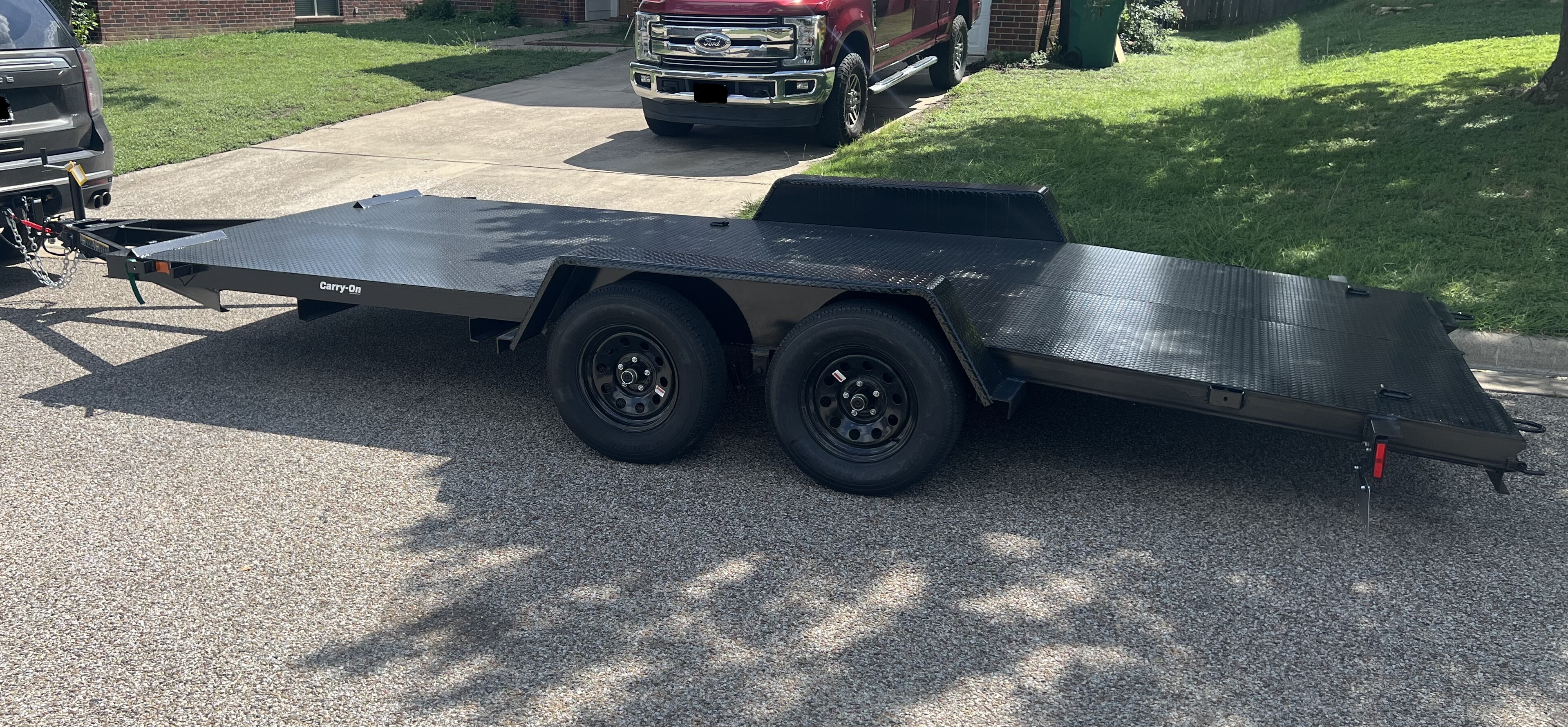 Car hauler trailer showing tie-down points and aluminum deck surface