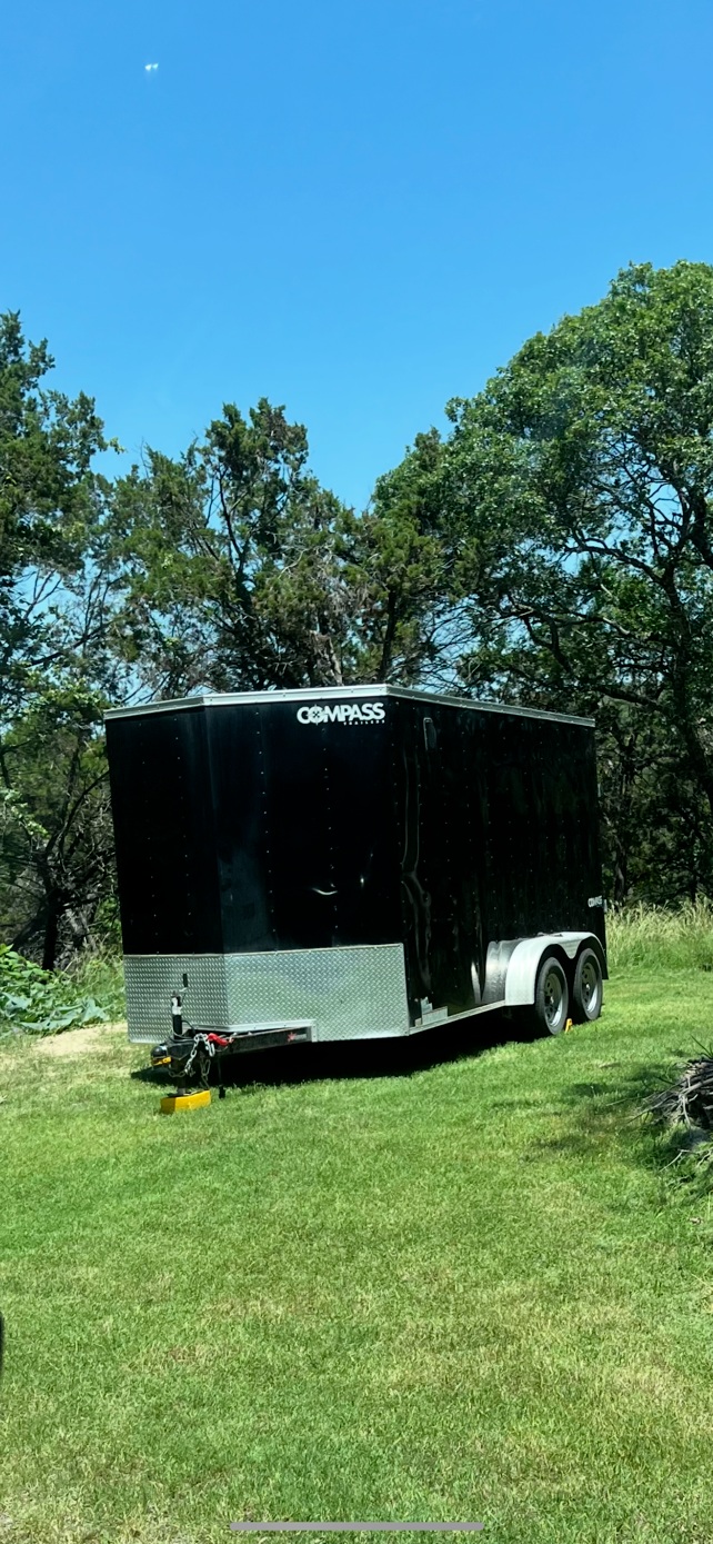 Side view of Compass enclosed trailer showing durable construction and towing hitch
