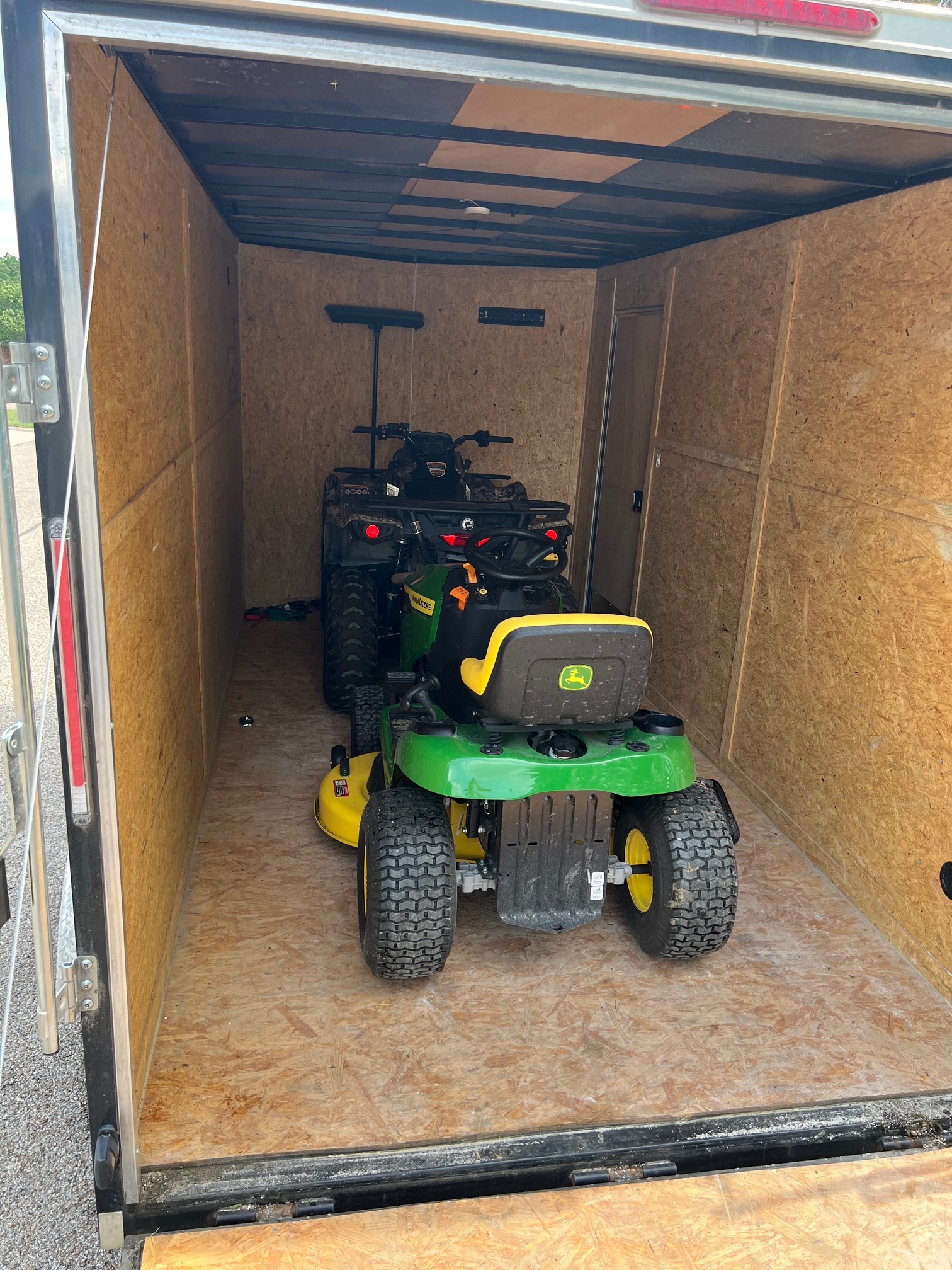 Enclosed trailer interior with tie-down points and LED lighting