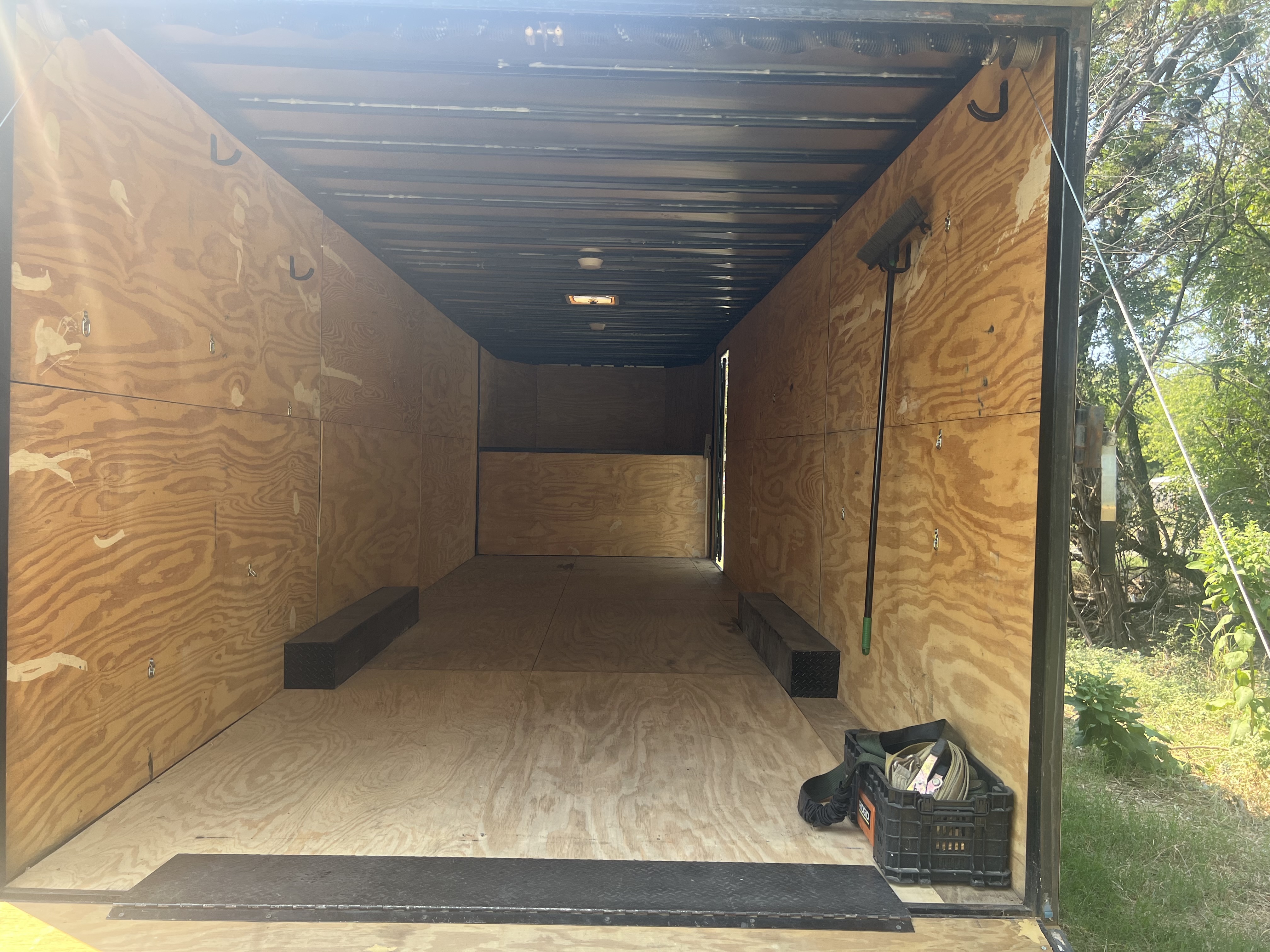 Interior of 35-foot gooseneck trailer with red pickup truck loaded inside showing spacious cargo capacity