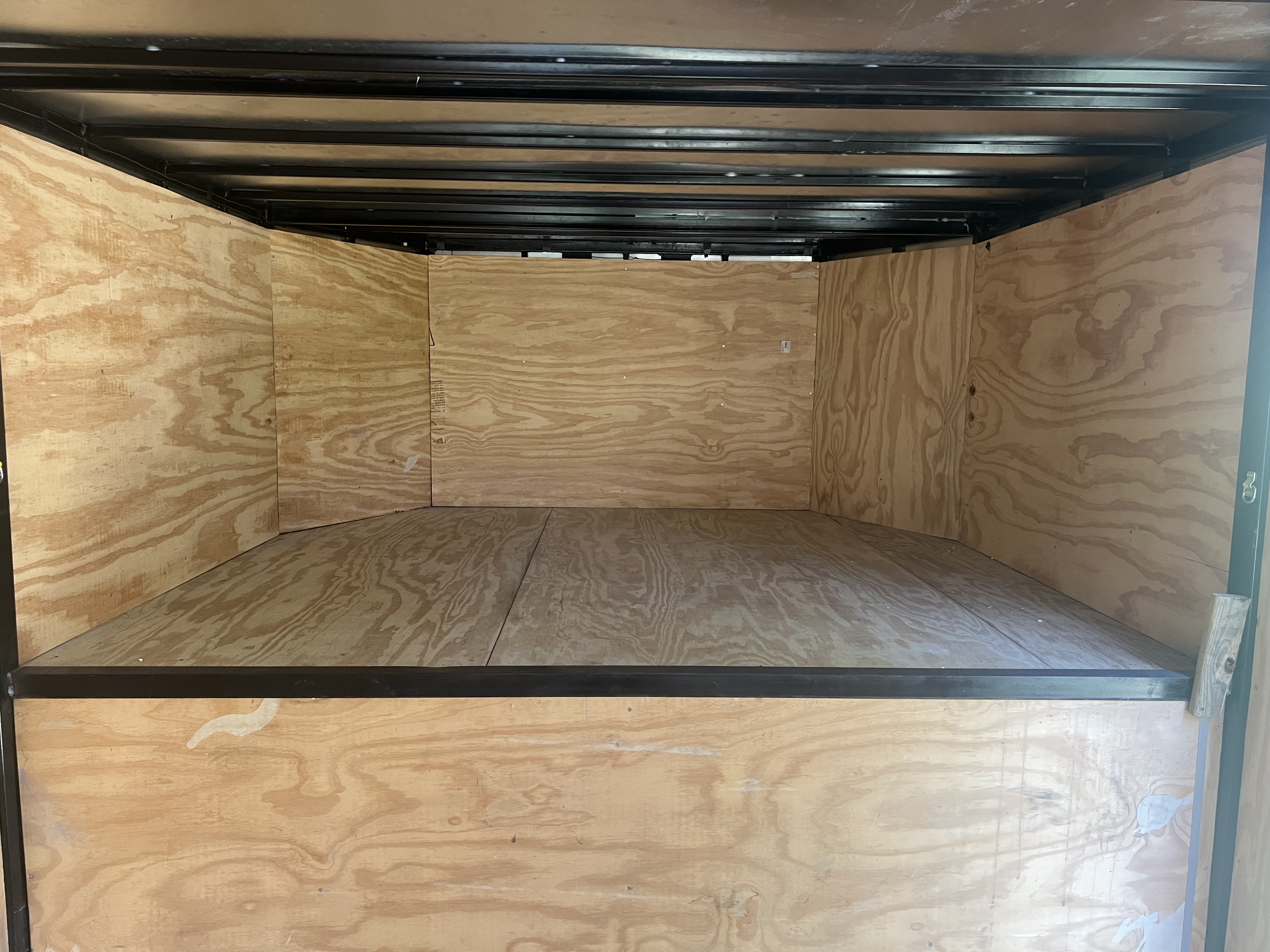 Full-length interior view of gooseneck trailer showing 35 feet of enclosed cargo space